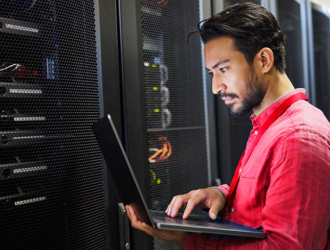 NPV Tech technician working on servers in a data centre aisle